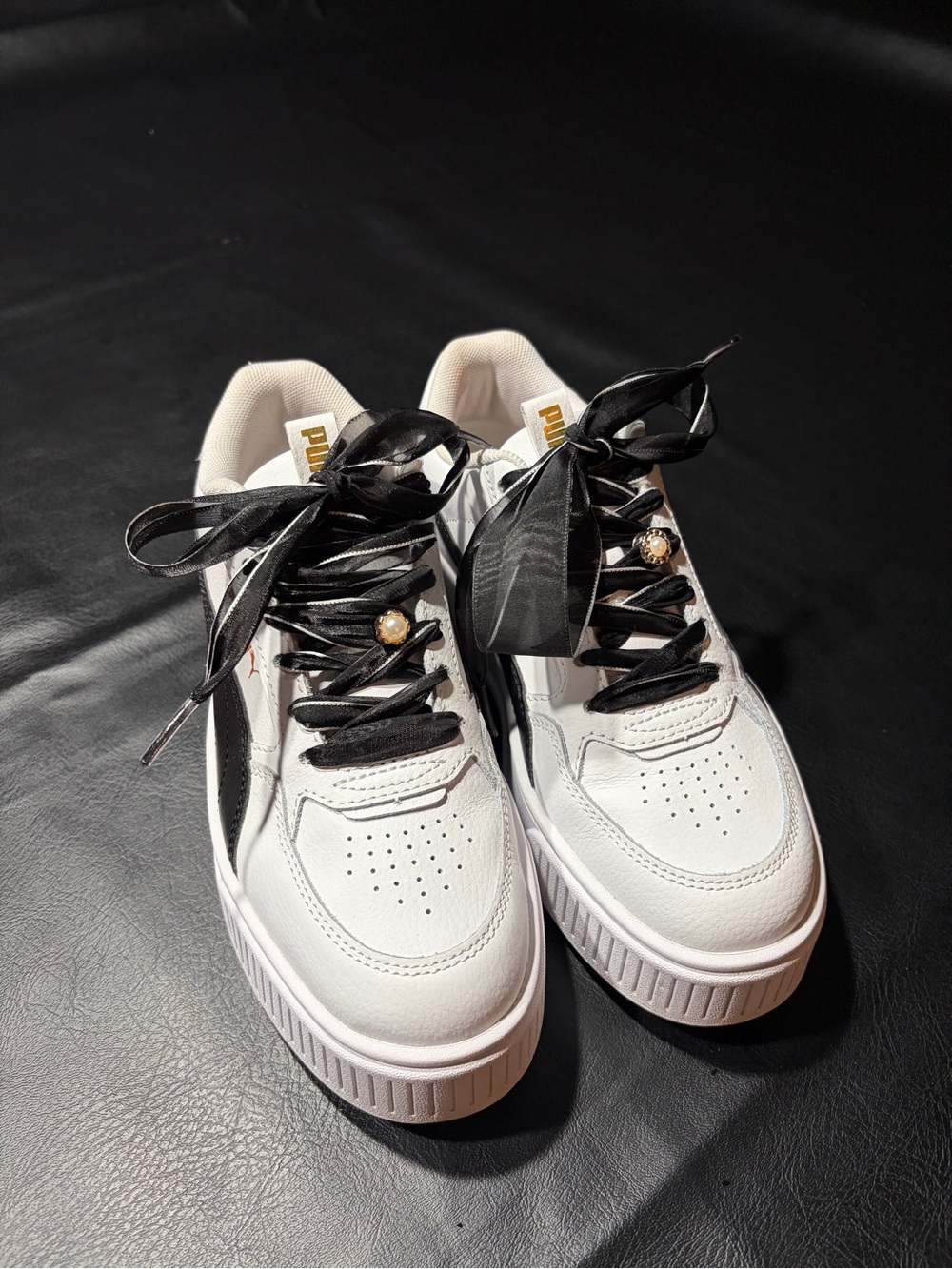 Puma White Sneakers with Black Accents and Gold Charm